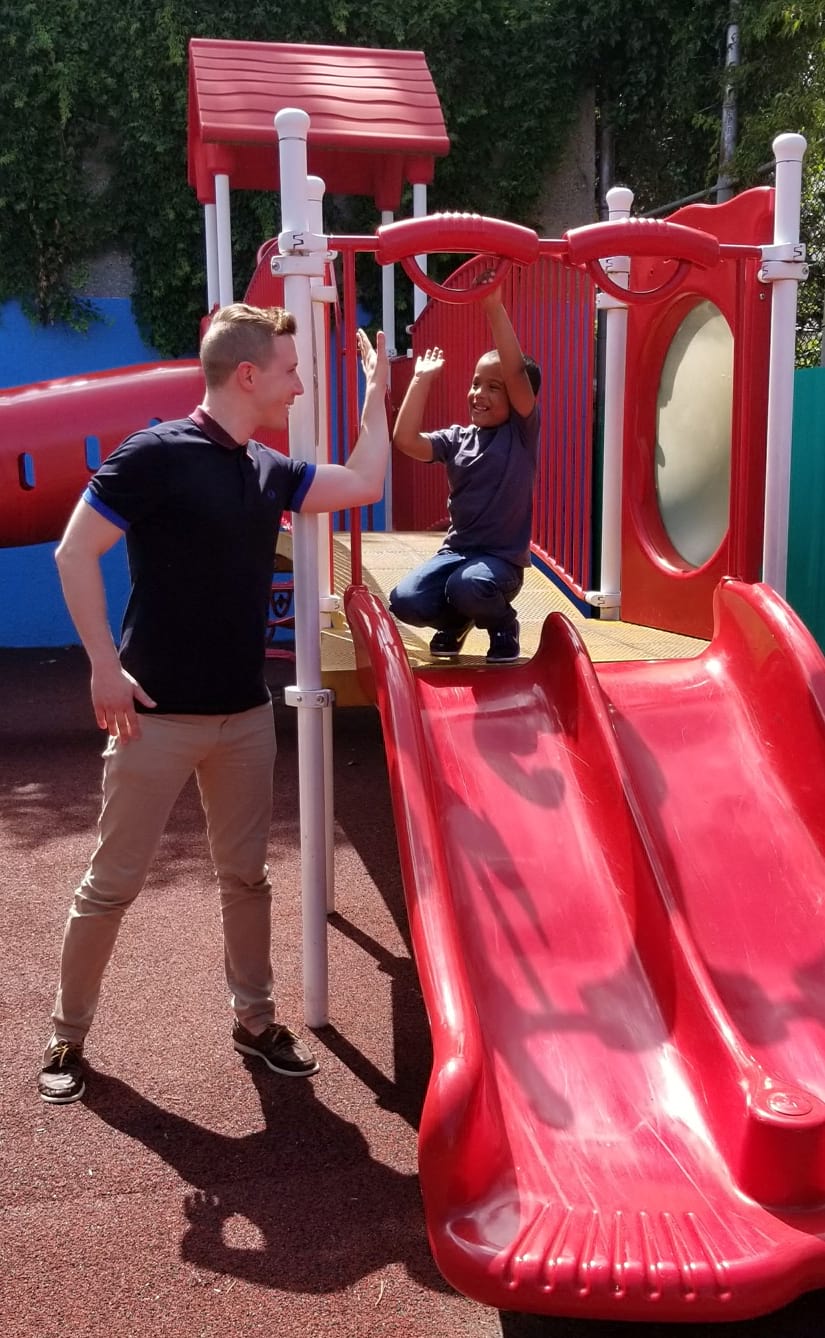 Daniel and student on a slide