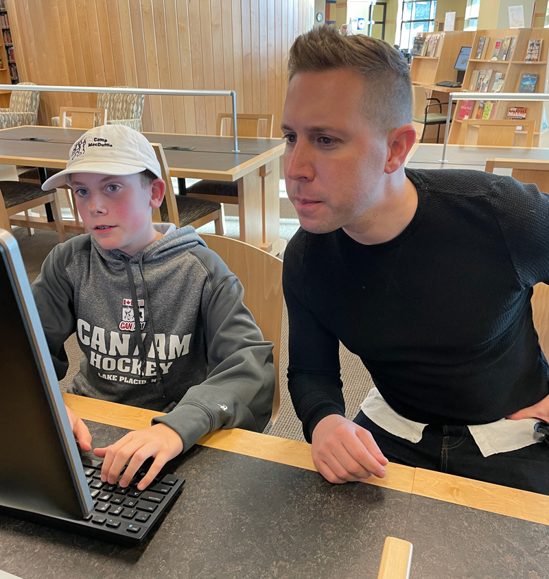 Daniel and student with a book